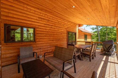 a wooden deck with a table and chairs on it at Aspen Summit by Railey Vacations in McHenry