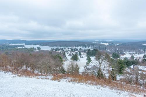 a snow covered hill with a view of a town at As You Wish by Railey Vacations in Oakland