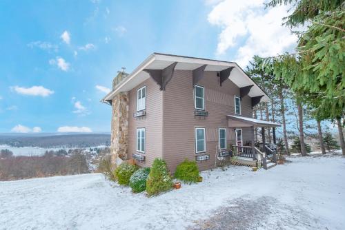 a house on a hill with snow on the ground at As You Wish by Railey Vacations in Oakland