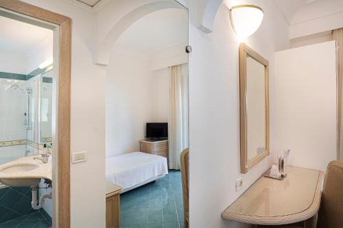 a bathroom with a sink and a mirror at Hotel Continental Ischia in Ischia Town