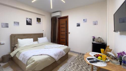 a bedroom with a bed and a table with a bowl of fruit at king pyramids in Cairo