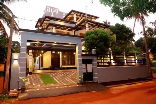 a small house with a courtyard in front of it at Induwara Beach Stay Thalalla in Delgalla
