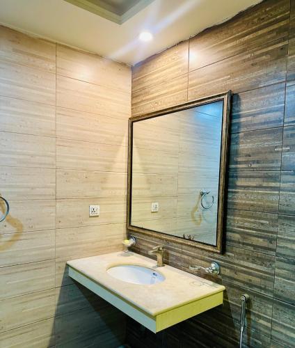 a bathroom with a sink and a mirror at Modern City Escape Bahria hieghts in Rawalpindi