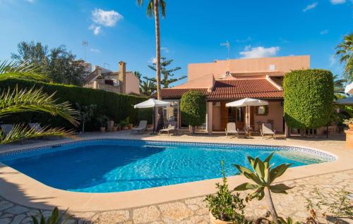 a swimming pool in front of a house at Casa Romantica De Sa Coma in Sa Coma
