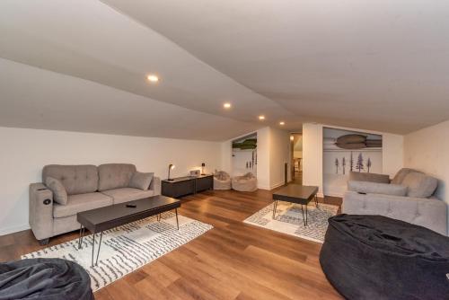 a living room with two couches and a table at Ballers Bungalow by Railey Vacations in Swanton