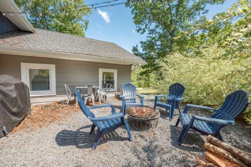 a group of blue chairs sitting around a fire pit at Ballers Bungalow by Railey Vacations in Swanton