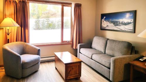 a living room with a couch and a chair at Cahilty #103 in Sun Peaks
