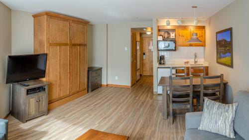 a living room with a kitchen and a dining room at Cahilty #204 home in Sun Peaks