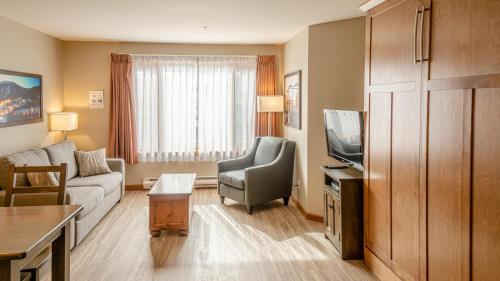 a living room with a couch and a tv at Cahilty #204 home in Sun Peaks