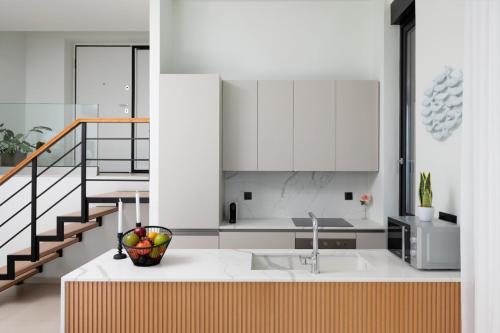 a kitchen with a bowl of fruit on a counter at Majestic View Villas in Agios Nikolaos