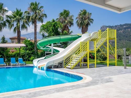 a water slide in a swimming pool with a slide at Pera Aura Resort Hotel & Spa - All Inclusive in Kemer