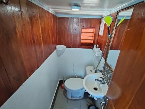 a small bathroom with a toilet and a sink at Sharing trip komodo 3d 2n in Labuan Bajo