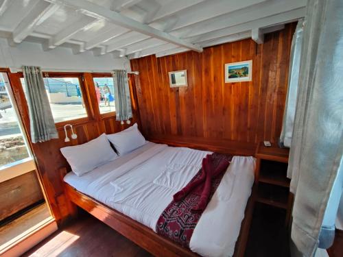 a bed in the back of a wooden boat at Sharing trip komodo 3d 2n in Labuan Bajo