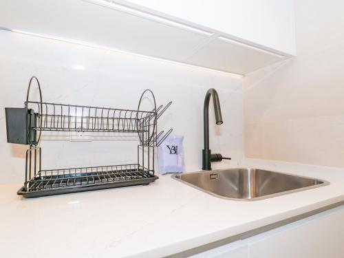 a kitchen counter with a sink and a faucet at YBH Atlantic Boutique in Vigo