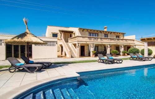 a villa with a swimming pool in front of a house at Catalina in Alcudia