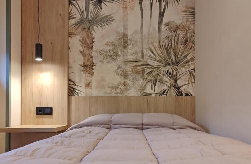 a bedroom with a bed with a painting on the wall at HOTEL RST. PADORNELO in Padornelo