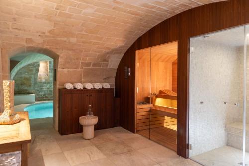a bathroom with a tub and a toilet in a room at Madame Drouot & Spa - Opera in Paris