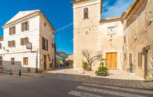an old building with a clock tower on a street at Can Roses in Moscari
