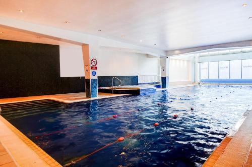a pool of water in a large room at Holland House Hotel Cardiff By Sunday in Cardiff