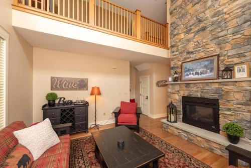 a living room with a fireplace and a couch at Bear Foot by Railey Vacations in Oakland