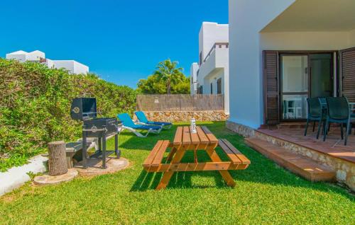 a backyard with a picnic table and a grill at Marina D'or Lv Casa 5 in Cala d´Or