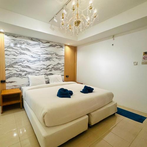a bedroom with a large bed with blue towels on it at Kohchang Cabana Big Hotel with swiming pool & Beach in Ko Chang