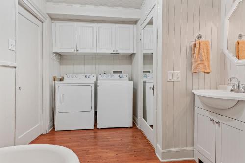 a kitchen with white cabinets and a white dishwasher at Le Toit Rouge - 3457 in Saint-Férréol-les-Neiges