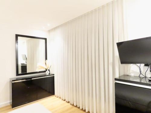 a room with a mirror and a black and white wall at THE white lotus in Eilat