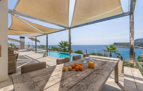 a wooden table with oranges on top of a house at Lifetime in Font de Sa Cala