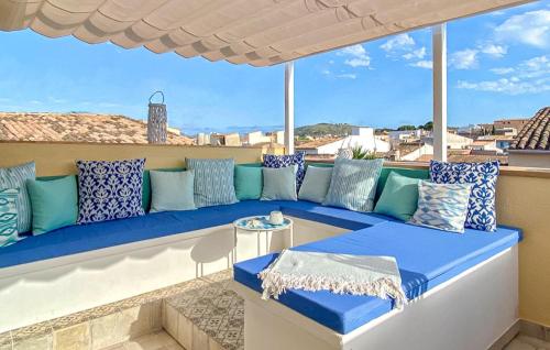 a blue couch sitting on a balcony at Casa Vida Arta in Artá