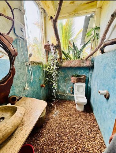 a dirty bathroom with a toilet and a sink at SD3M ART GALLERY Villa in Dickwella
