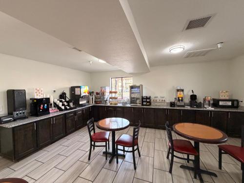 a restaurant with two tables and chairs and a counter at Albuquerque Hotel West by IHG in Albuquerque