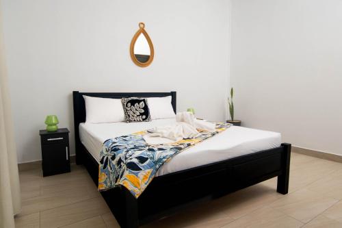 a bedroom with a bed with a mirror on the wall at Villa Clif-Beau in Albion