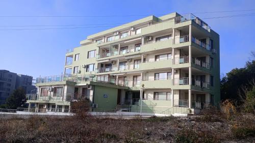 a tall building with balconies on the side of it at Sea View in Topola