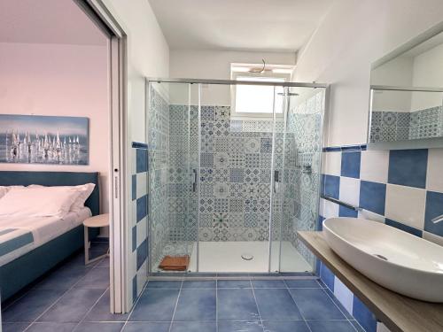 a bathroom with a shower and a tub and a sink at ItineraBaiaVerde Rooms & Breakfast in Gallipoli