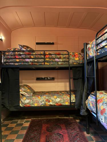 a room with two bunk beds in a room at BOHOSTEL in Macclesfield