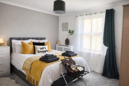 a bedroom with a large bed with a basket on it at Centrally Located a Home from Home - Free Parking in Kent