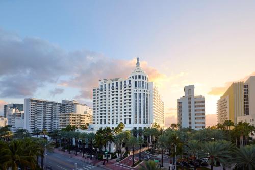 a city skyline with tall buildings and palm trees at Loews Miami Beach Hotel in Miami Beach