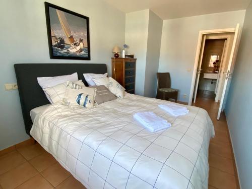 a bedroom with a large white bed in a room at Charming Duplex in Knokke-Heist