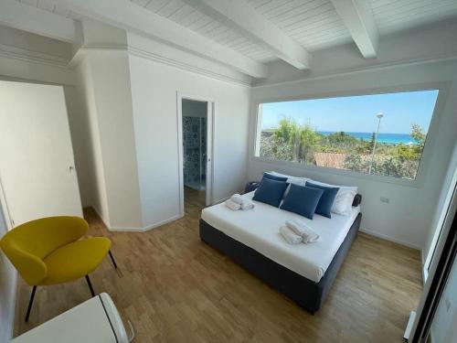 a bedroom with a bed and a large window at ItineraBaiaVerde Rooms & Breakfast in Gallipoli