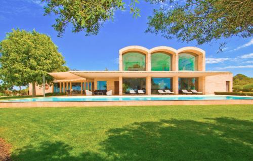a large house with a swimming pool in a yard at Los Arcos in Felanitx