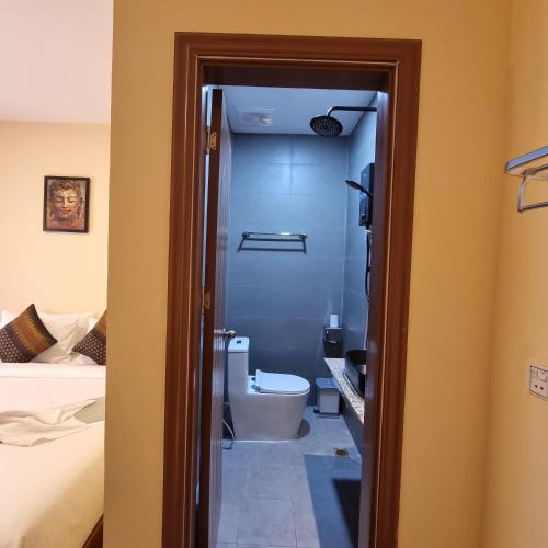 a bathroom with a tub and a toilet in a room at STAY SWEET in Phnom Penh