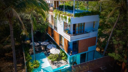 an overhead view of a house with a swimming pool and palm trees at Agua de Luna Hotel Boutique, San Pancho Nayarit in San Francisco