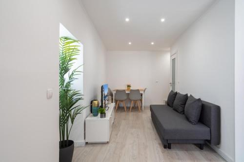 a living room with a couch and a table at Authentic Porto Home by HostWise in Porto