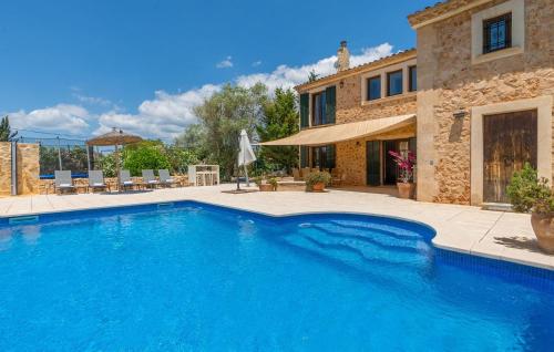 a swimming pool in front of a house at Kiana in Santa Eugenia