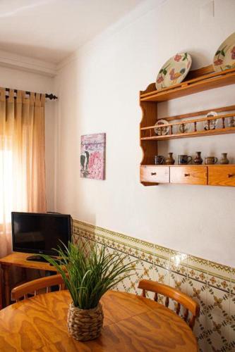 a dining room with a table with a plant on it at Casa Maria in Albufeira