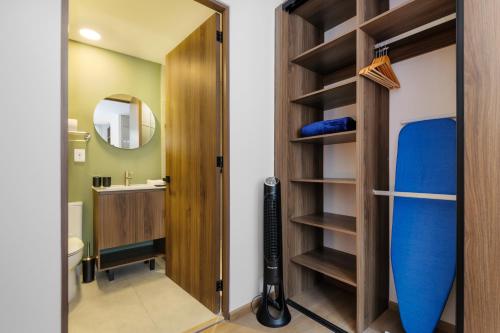 a bathroom with a door open to a bathroom with a surfboard at Sullivan by Wynwood House in Mexico City