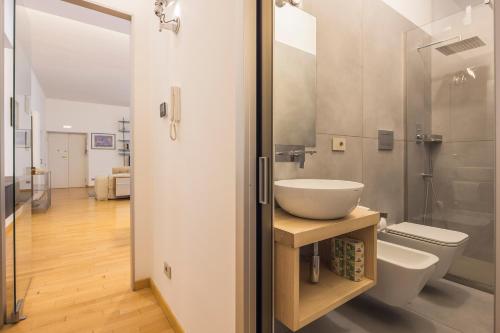 a bathroom with a sink and a toilet at Casa Boutique Mareluna - Luxury Apartments by Mareluna Hotel in Salerno