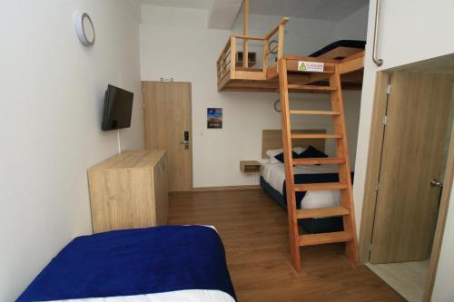 a small room with a bunk bed and a ladder at Normandía Tower in Bogotá
