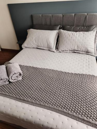 a bed with two pillows on top of it at Premium Apartment in Bagé in Bagé